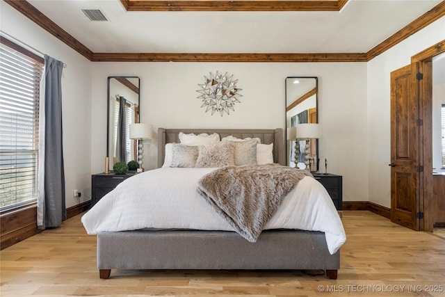 bedroom featuring crown molding and light wood-type flooring