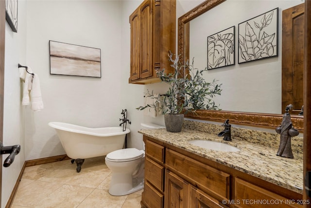 bathroom with vanity, toilet, a tub, and tile patterned floors