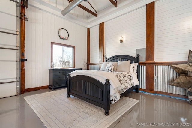 bedroom featuring ceiling fan and wooden walls