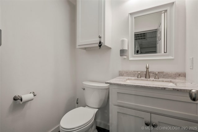 bathroom featuring vanity and toilet