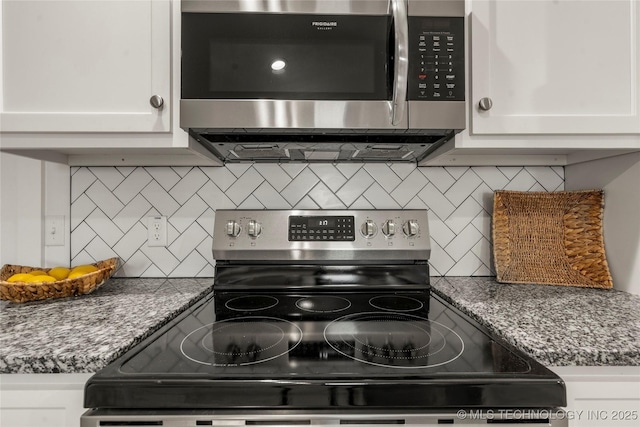 kitchen featuring decorative backsplash, white cabinetry, and appliances with stainless steel finishes