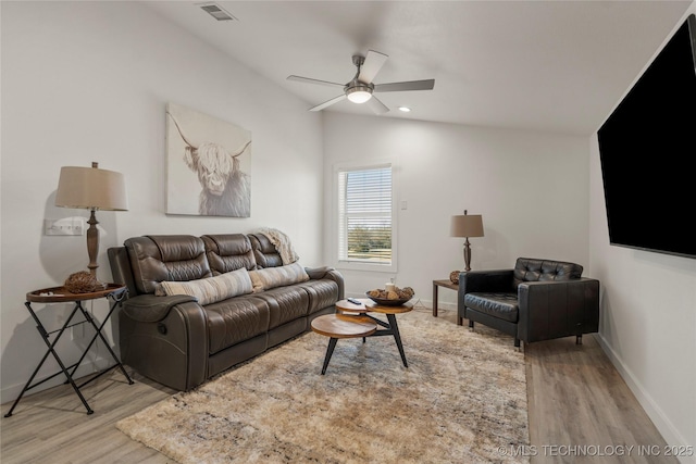 living room featuring ceiling fan, light hardwood / wood-style flooring, and lofted ceiling