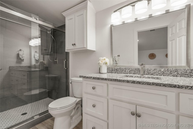 18342 S 132nd E Ave, Bixby, OK 74008 - bathroom featuring a stall shower, wood finished floors, toilet, and vanity
