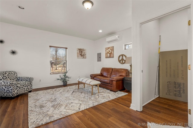 living room featuring dark wood-type flooring, electric panel, and an AC wall unit