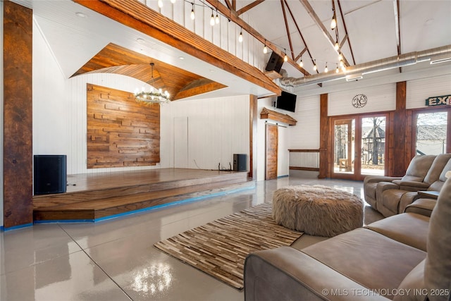 living room with a notable chandelier, high vaulted ceiling, wooden walls, and brick ceiling