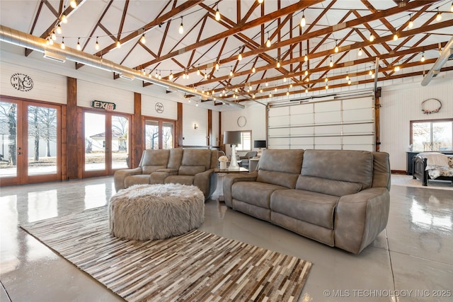 living room with high vaulted ceiling and french doors