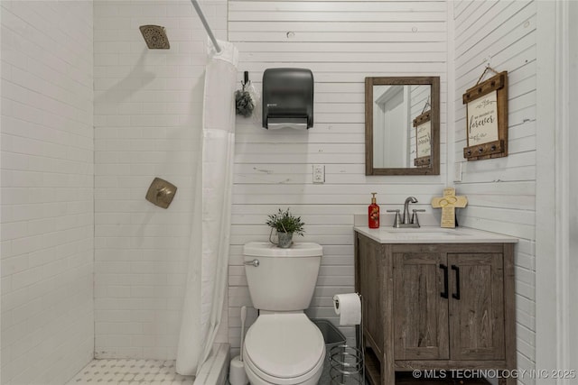 bathroom featuring wooden walls, toilet, vanity, and a shower with shower curtain