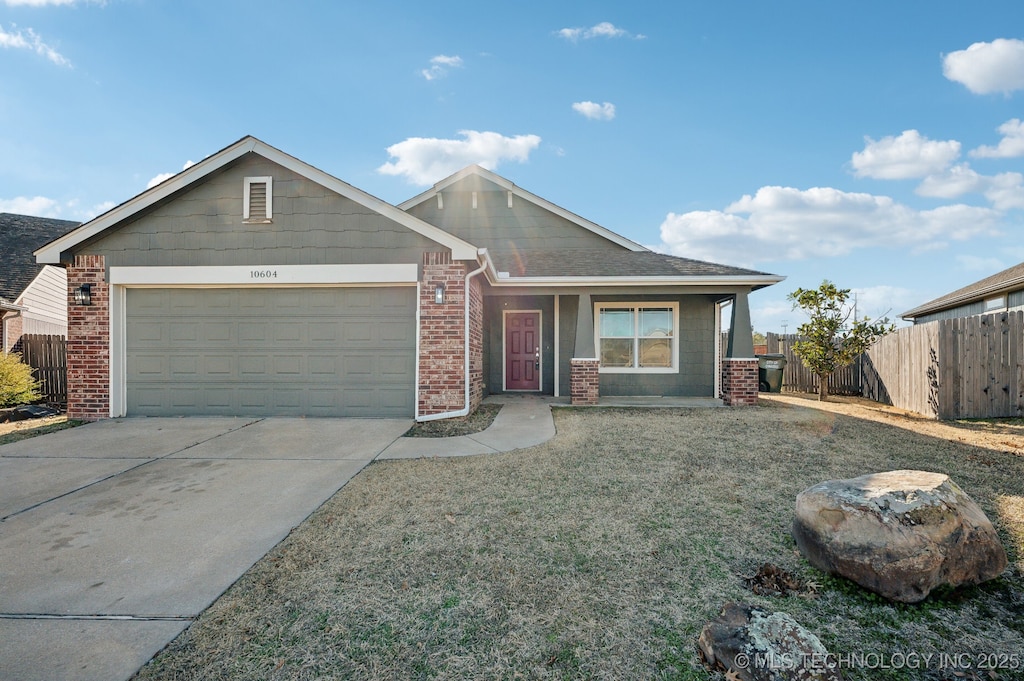 view of front of house with a garage and a front lawn