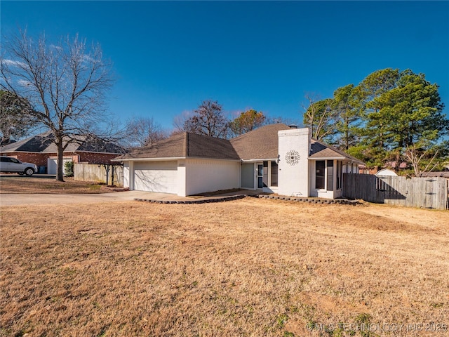 view of front of property with a garage and a front lawn