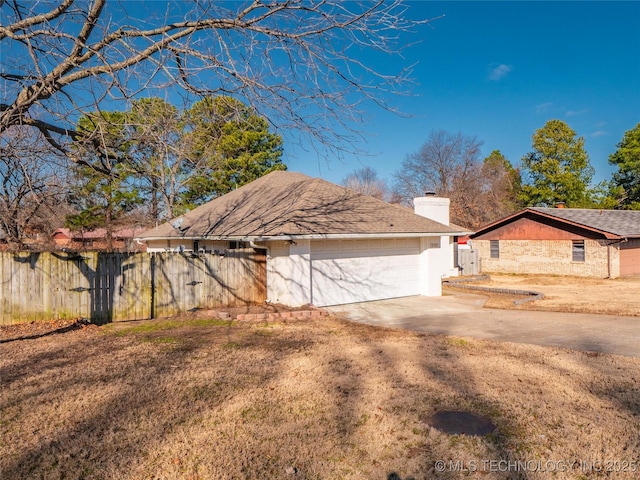 view of front of house featuring a garage and a front lawn