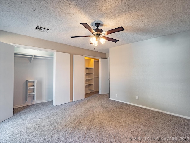 unfurnished bedroom with ceiling fan, a textured ceiling, and carpet flooring