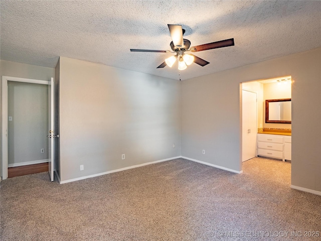 unfurnished bedroom with ceiling fan, a textured ceiling, ensuite bathroom, and light carpet