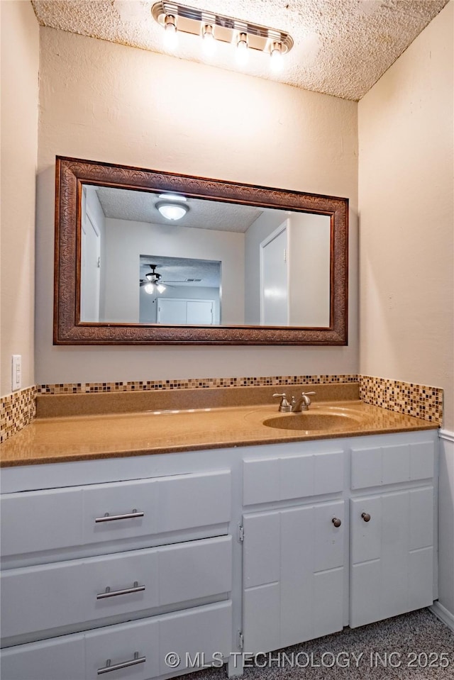 bathroom with a textured ceiling and vanity