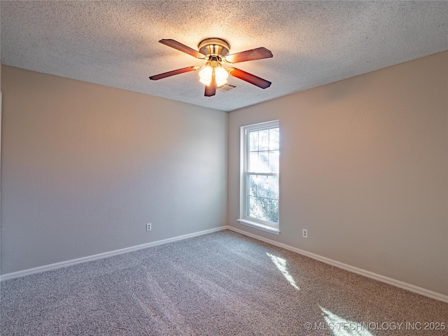 carpeted spare room featuring ceiling fan and a textured ceiling