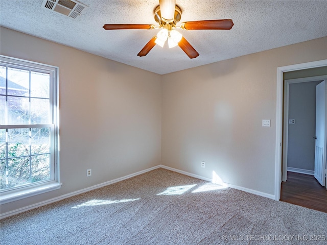 unfurnished room with carpet, a wealth of natural light, and a textured ceiling