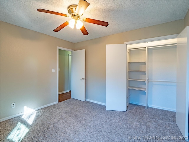 unfurnished bedroom with ceiling fan, carpet, a closet, and a textured ceiling