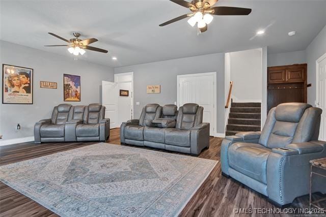 living room with dark wood-type flooring and ceiling fan