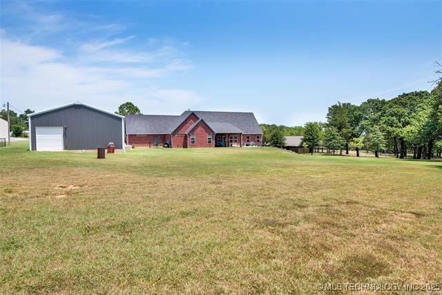 view of yard with a garage and an outdoor structure