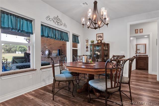 dining area with a notable chandelier and hardwood / wood-style flooring