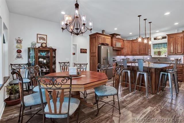 dining room featuring dark hardwood / wood-style flooring and a chandelier