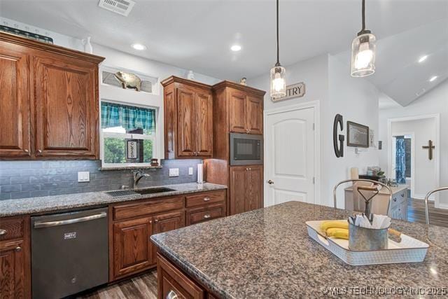 kitchen with dishwasher, dark hardwood / wood-style flooring, sink, hanging light fixtures, and built in microwave