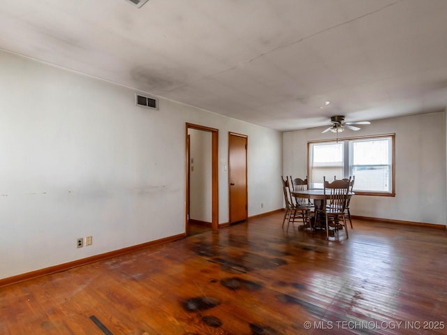 unfurnished dining area featuring ceiling fan and dark hardwood / wood-style flooring