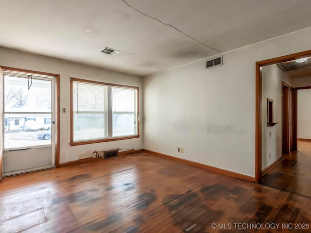 unfurnished room with dark wood-type flooring