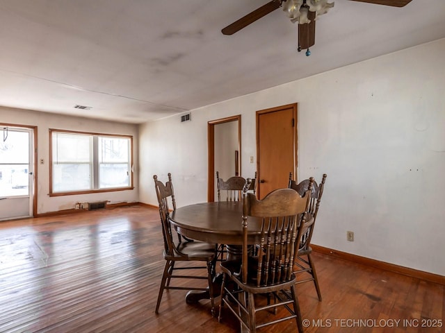 dining space with ceiling fan, dark wood-type flooring, and plenty of natural light