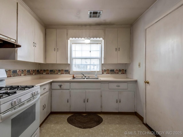 kitchen with sink, white cabinetry, and white gas range oven