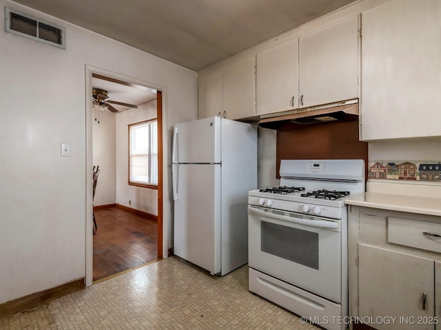 kitchen with ceiling fan, white appliances, and white cabinets