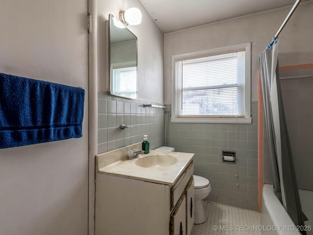 full bathroom featuring toilet, tile walls, tile patterned floors, vanity, and shower / bathtub combination with curtain