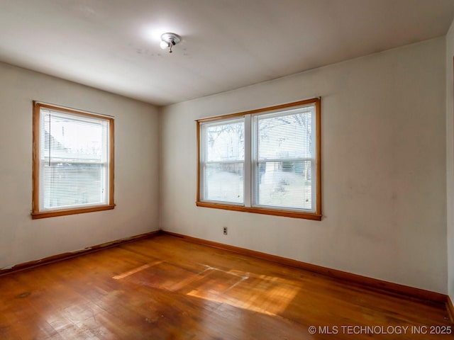 unfurnished room featuring hardwood / wood-style flooring