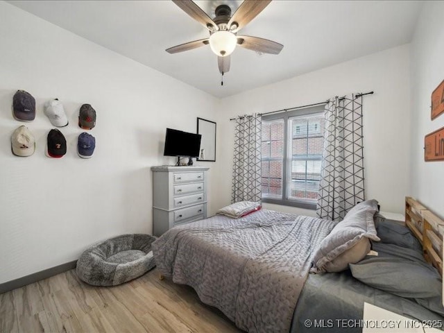 bedroom with ceiling fan and wood-type flooring