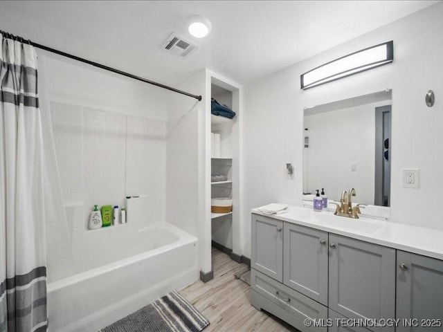 bathroom with vanity, hardwood / wood-style flooring, and shower / bath combo