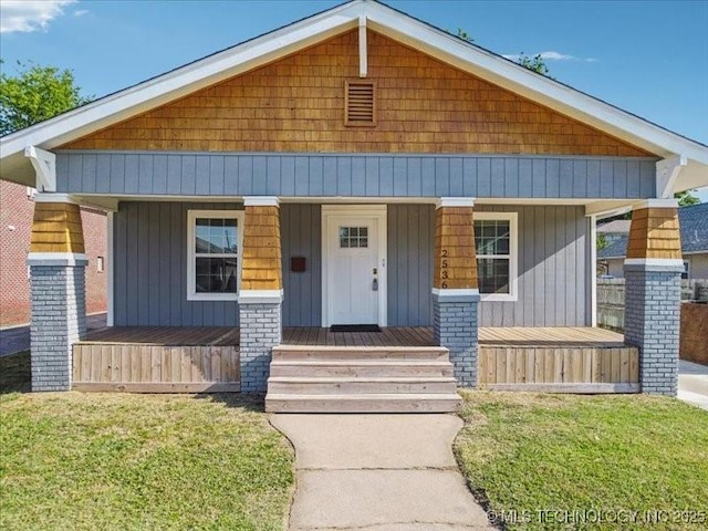 bungalow-style house featuring a front yard and a porch