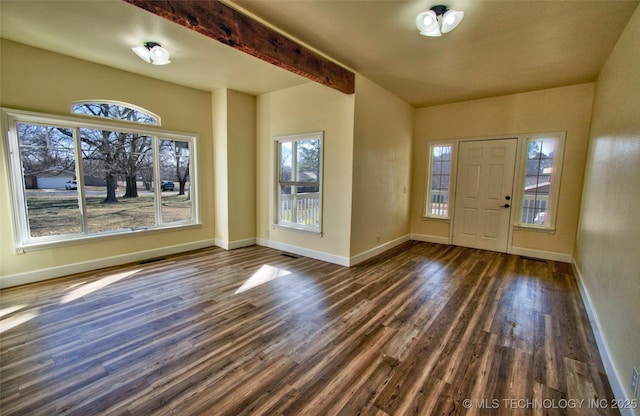 foyer featuring beamed ceiling and dark wood-type flooring