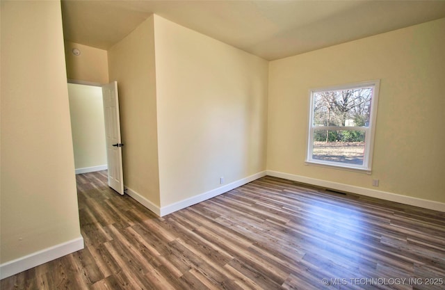 spare room with dark hardwood / wood-style floors