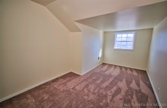 bonus room featuring lofted ceiling and carpet