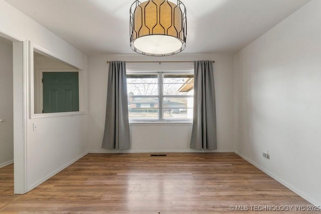 empty room with light hardwood / wood-style flooring