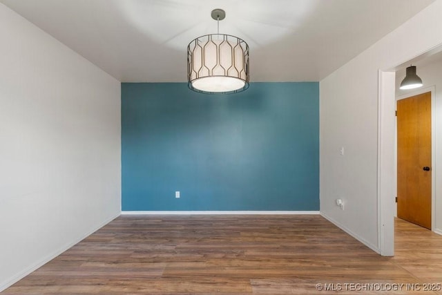 unfurnished room with hardwood / wood-style floors