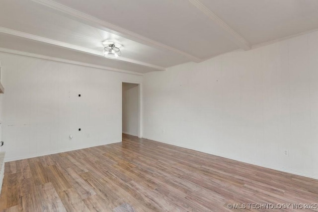 empty room with light wood-type flooring and beamed ceiling