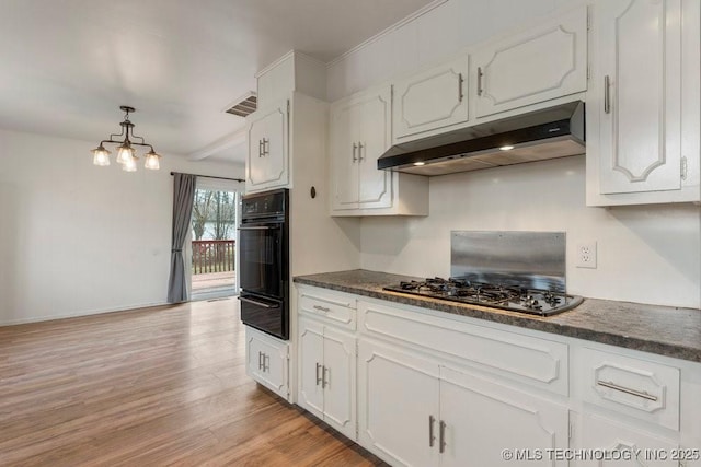 kitchen featuring white cabinets, hanging light fixtures, light hardwood / wood-style floors, and black gas cooktop