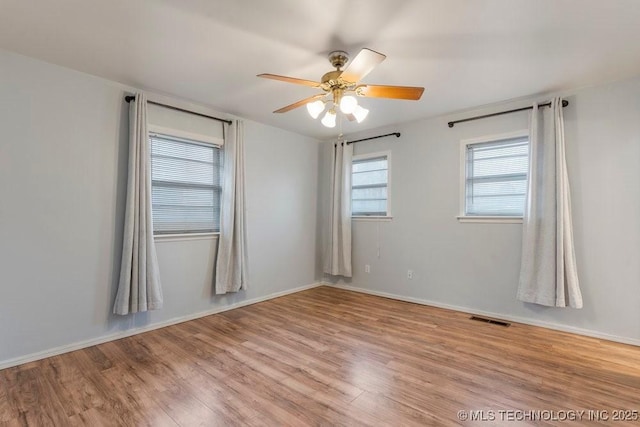 spare room with light hardwood / wood-style floors and ceiling fan