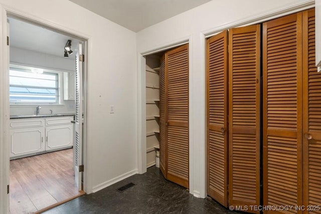 hall with sink and dark hardwood / wood-style flooring