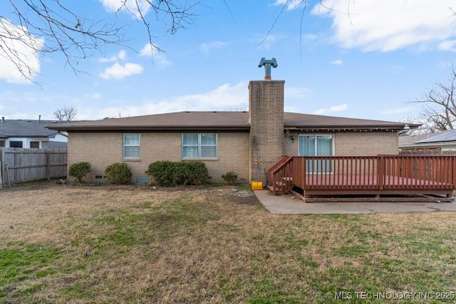 back of property featuring a deck and a yard