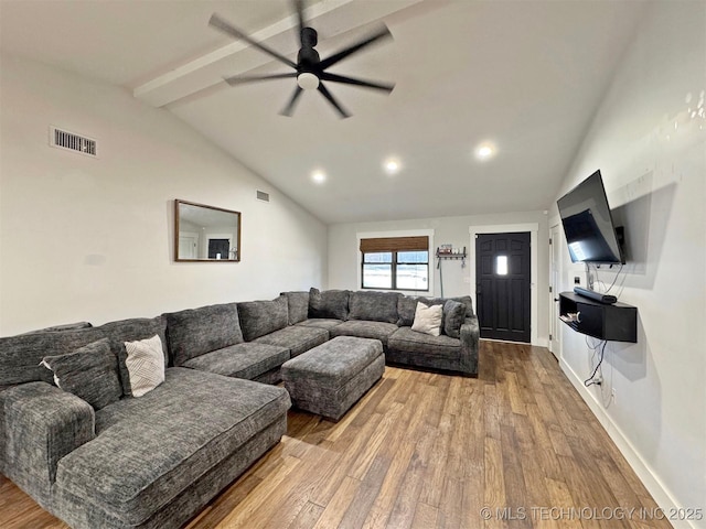 living room featuring ceiling fan, light hardwood / wood-style flooring, and lofted ceiling with beams