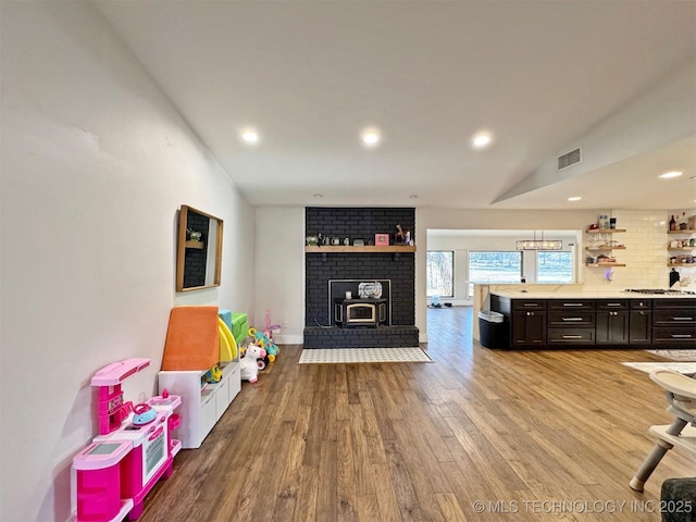 rec room featuring vaulted ceiling and light hardwood / wood-style floors