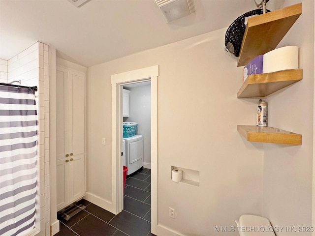 bathroom featuring walk in shower, washing machine and dryer, and tile patterned floors