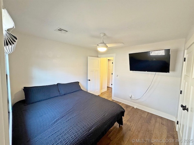 bedroom with hardwood / wood-style flooring and ceiling fan