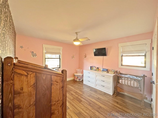 bedroom featuring light hardwood / wood-style flooring and ceiling fan